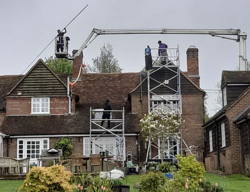 The Moss Cleaners using cherry picker and scaffolding to clean roof safely and professionally in 40 Plevna Rd, Hampton TW12 2BP, UK, 40 Plevna Rd, Hampton TW12 2BP, UK